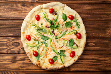 Italian pizza with avocado salmon  tomatoes and mozzarella photography. top view
