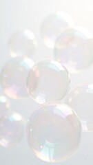 Close-up of colorful, translucent soap bubbles with iridescent reflections floating against a bright white background. Perfect for themes of purity, playfulness, and lightness. Ideal for creative, abs