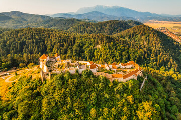 Aerial view of Rasnov Fortress and Rasnov city and forest around in Brasov, Transylvania, Romania