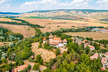 Obraz premium Viscri, Romania. Blue old painted traditional house from village, Transylvania. The Viscri fortified church