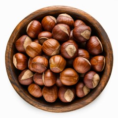 Fototapeta premium Hazelnut Harvest: A close-up shot of a wooden bowl overflowing with shelled hazelnuts, capturing their rich brown color and textured surfaces.