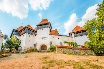 Viscri, Romania. Blue old painted traditional house from village, Transylvania. The Viscri fortified church