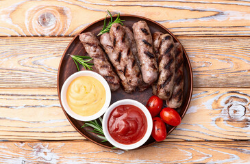 Grilled beef sausages with rosemary sauce and tomatoes photography . Top view