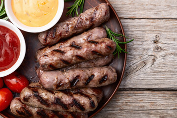 Grilled beef sausages with rosemary sauce and tomatoes photography . Top view