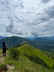 Obraz premium Latino male hiker takes pictures of mountains in Colombia