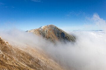 Velky Krivan, Mala Fatra, Slovakia. Top, peak and summit of mountain. Inversion and hill above clouds. Sunny with blue sky. Copy space.