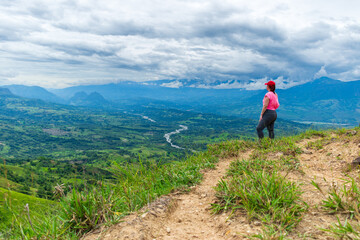 Obraz premium Latina woman hiker enjoys the mountains in Colombia
