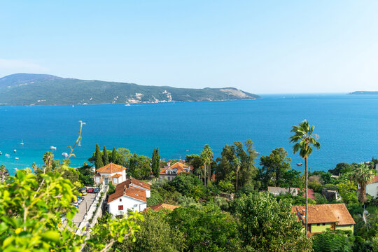 View of Bay of Kotor from high point of coastal city Herceg Novi, Montenegro. Terracotta roofs of seaside city. Adriatic Sea