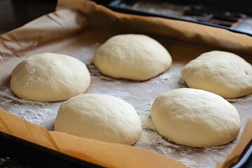 Fototapeta premium Freshly Kneaded Dough Resting on a Baking Tray in a Cozy Kitchen During the Afternoon
