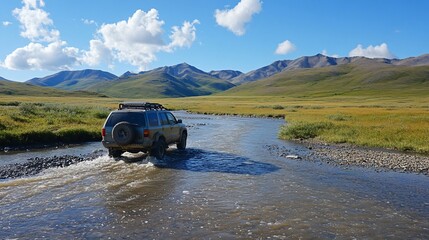 An off-road vehicle traversing a river in a mountainous landscape under a clear blue sky.