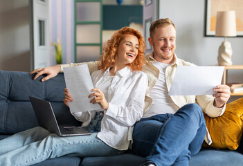 Finance and family paperwork. Couple checking bank account, financial statements and reports, doing...