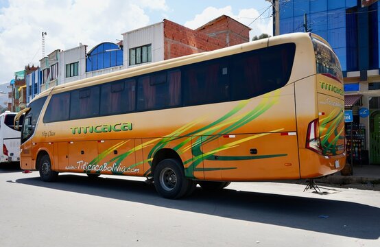 Orange Marcopolo Titicaca tourist Coach. Khasani, Peru. October 9, 2023. 
