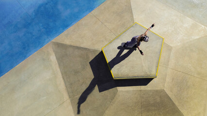 Aerial view of a skater skillfully performing tricks in a vibrant urban setting