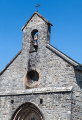 Bells toll in the serene stone chapel in Roncevaux along the Camino de Santiago, French Pyrenees