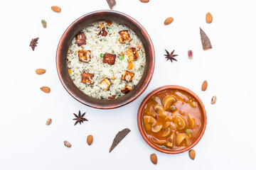 Paneer Biryani with Mushroom Curry served in clay pot isolated on white background top view of indian, pakistani and bangladeshi food