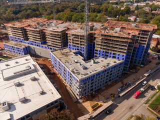 Fototapeta premium Drone Images of Concrete Highrise Construction In Raleigh NC On A Sunny Day 