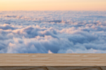 Wooden table and blue sunshine sky with clouds. Summer or spring picnic background. Empty space...