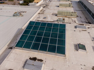 Daytime Drone Images of a Large Commercial TPO Roof With Unique Skylights and an Atrium
