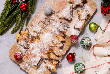 Puff Pastry Christmas Tree with Nutella on a Christmas rustic background