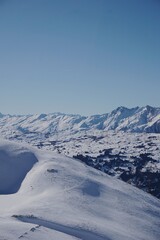 Expansive Snow-Covered Alpine Landscape Under Clear Blue Sky
