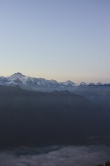 Alpine Mountain Range at Dusk with Misty Valleys