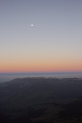 Mountain View at Dusk with the Moon and Soft Twilight Colors