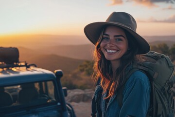 Smiling woman in hat enjoys sunset during adventure in nature