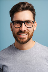 Fototapeta premium Portrait of handsome, smiling Hispanic man wearing stylish eyeglasses, fashion model