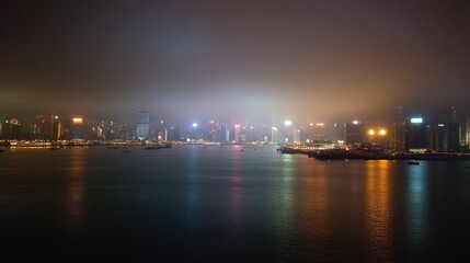 Naklejka premium Night View of Hong Kong Skyline Across Victoria Harbour