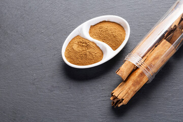 Cinnamon Sticks and Ground Spice on Slate