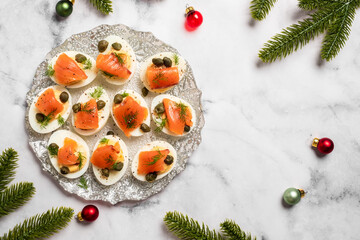 A plate of appetizers with a festive background of Christmas decorations