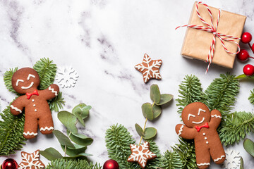 A Christmas scene with two gingerbread men, a box, and a star