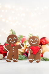 Two gingerbread men holding a heart in their hands