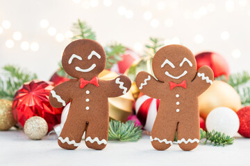 Two gingerbread men are smiling and wearing bow ties