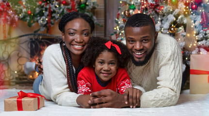 Christmas Family Portrait Near Xmas Tree At Home. Black Father, Mother And Their Little Daughter Celebrating Winter Holidays Together