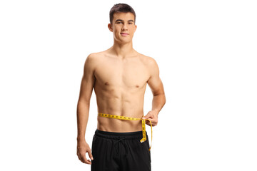 Fototapeta premium Young man with naked torso measuring his waist