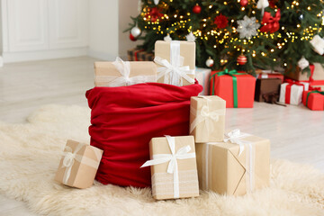 Santa bag full of Christmas presents at home