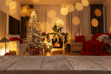 Empty table in room with Christmas tree, bokeh effect