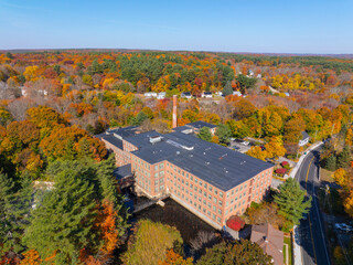 Hayward mill aerial view in fall with fall foliage at 26 North Street in East Douglas village, town of Douglas, Massachusetts MA, USA. 