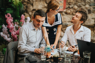 A group of professionals engaged in a collaborative discussion outdoors at a cozy cafe, highlighting teamwork and creativity in a relaxed environment.