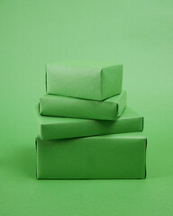 collection of roughly wrapped boxes in various sizes on green background