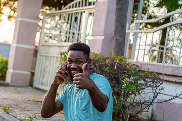 Young African American guy using mobile phone