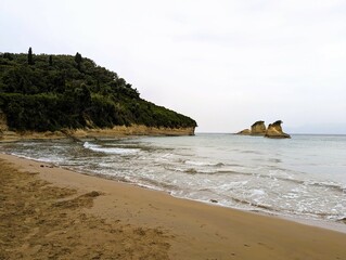 Lonely abandoned sandy beach at a bay on the island of Corfu in Greece, holiday on Corfu