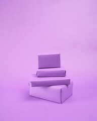 collection of roughly wrapped boxes in various sizes on purple background