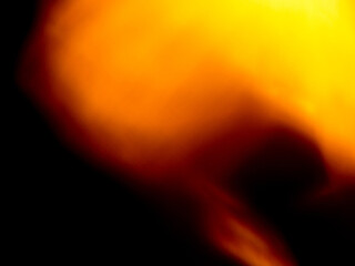 Light orange warm color light leak on dark background for design use and special effects.