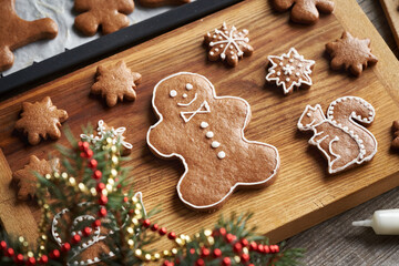 Decorating homemade gingerbread Christmas cookies with white icing