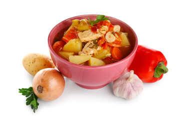 Bowl with delicious beef stew and different ingredients on white background