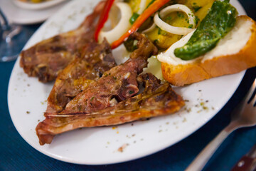 Baked under tasty lamb served with potatoes and bread at plate