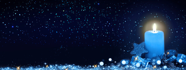 Blue Advent candle isolated on stars sky background .