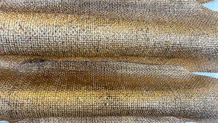 Close-up of a textured golden surface with reflective, shimmering details and intricate patterns. Perfect for modern art, luxury design, metallic textures, and creative backgrounds in design projects.